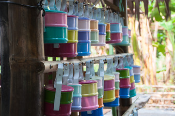Colorful tiffin lunchbox hanging bamboo. Nature lovers with a box of rice used repeatedly