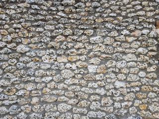 huge ancient wall made of many sea stones, pattern of ancient sea stone wall