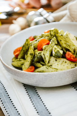 Pasta with pesto sauce and nuts on a the table