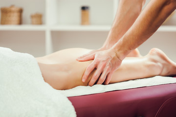 Young woman is having leg massage on spa treatment. 