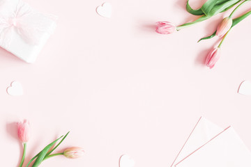 Valentine's Day composition. Tulip flowers, envelope on pastel pink background. Valentines day,...