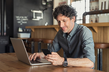 Mature businessman working at cafe