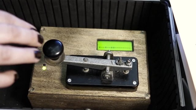 Woman typing a message using Morse code
