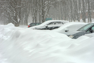 Cars left in the snowdrifts. Winter day.