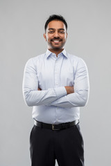 business, office worker and people concept - smiling indian businessman in shirt over grey...