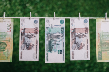 Fototapeta na wymiar rubles banknotes hanging with clothespins on clothesline, money laundering concept