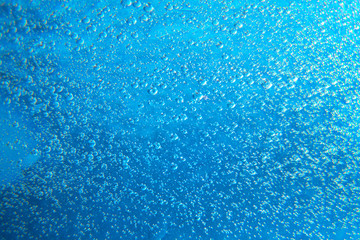 Drops of water on the glass. Marine abstract background. Air bubbles texture