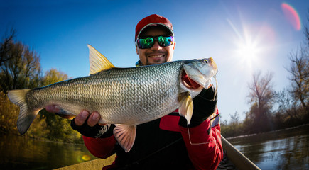 Fishing. Fisherman and trophy Asp.