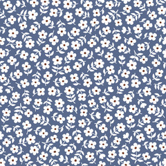 Seamless ditsy floral pattern in vector. Small white flowers on a blue background.