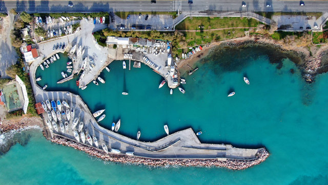 Aerial drone bird's eye view of small marina with boats docked in Voula, Athens riviera, Attica, Greece