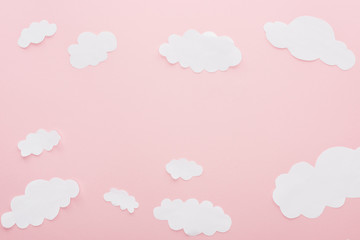 top view of white paper clouds isolated on pink with copy space