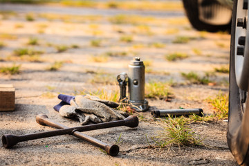 Socket wheel wrench and jack lying on ground
