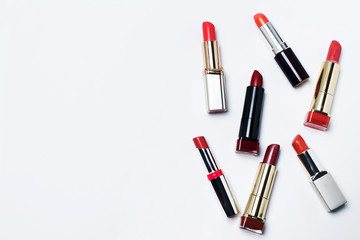 Obraz premium Makeup brush and lipstick on a white background