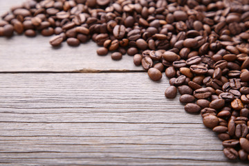 Natural coffee beans on grey wooden background