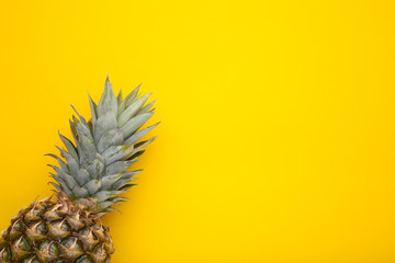 Fresh pineapple on a yellow background