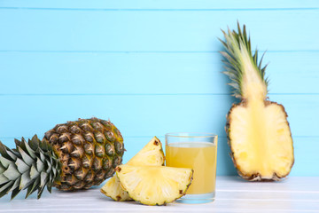 Fresh pineapple juice in the glass on blue background