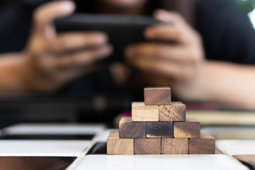 Growing business concept. Business Woman picking domino blocks for filling the missing dominus and protect domino to fail.