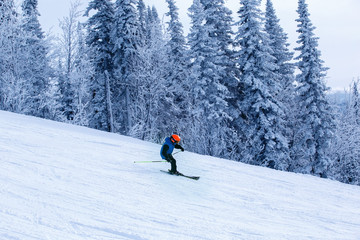 Skier skiing downhill in high mountains. Winter fun