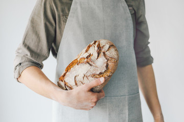 Baker or chef holding fresh made bread
