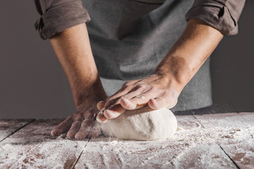 Chef making and kneading fresh dough
