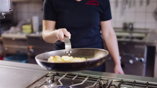 Fried potatoes are fried in a pan in the kitchen - Bratkartoffeln werden in einer Pfanne in der K&uuml;che angebraten 4k PRORES Footage