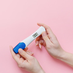 Woman shows positive pregancy test