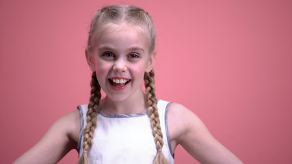 Beautiful girl with braids smiling and having fun, happy winner dance, emotions