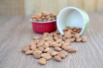 Almond nut on wood background.