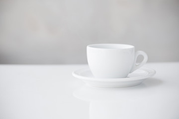white cup on table