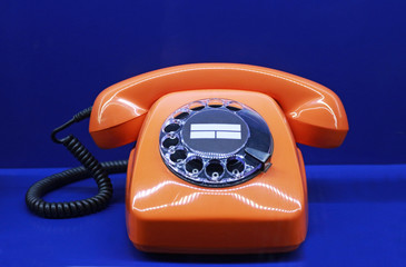 orange colored retro telephone with dial