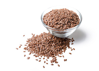 Linseeds in a glass bowl on white background