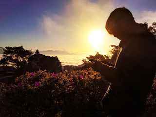 Men standing in the midst of the natural bright sky and shining. Siluette photos