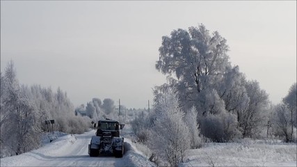 Tver region. Sonkovsky district. Russia. 
 28 January 2019. Clearing snow from the road. Tractor grader clears snow from the road. 