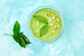 Homemade pesto sauce in glass jar. Top view.