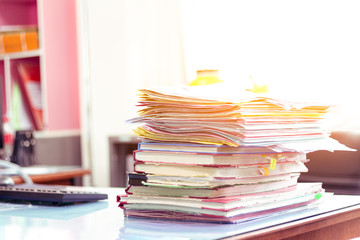 Stack of documents placed on a business desk in a business office.