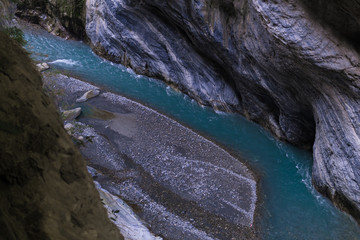 Blue colored river with layered rock formations