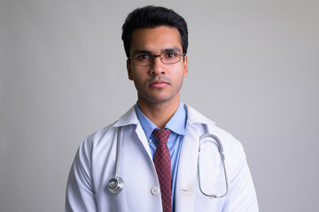 Portrait of young Indian man doctor wearing eyeglasses
