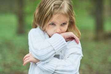 Portrait of sad unhappy little girl. Little sad child is lonesome. upset and distraught angry facial expression.