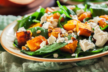 Roasted pumpkin salad with spinach and nuts