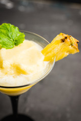 Freeze pineapple cocktail in martini glass. Selective focus. Shallow depth of field.