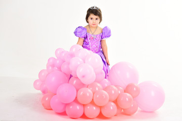 Fototapeta na wymiar Party balloons. Happy birthday. Little girl in princess dress. Kid fashion. Little miss in beautiful dress. Childhood and happiness. Childrens day. Small pretty child. Enjoying great story