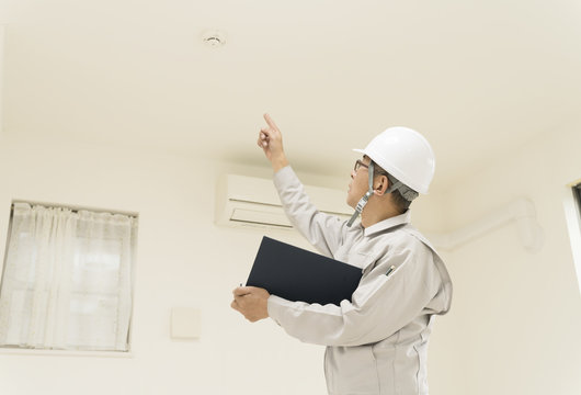 住宅とヘルメットの作業員 火災警報装置を指差し 確認 Stock 写真 Adobe Stock