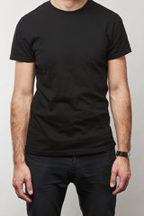 partial view of man in black t-shirt with copy space isolated on grey