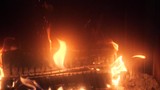 red flames of otgryaschih natural wood by the fireplace
