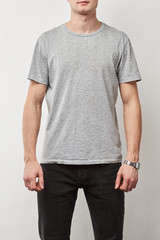 Obraz premium partial view of man in t-shirt with copy space isolated on grey