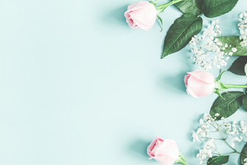 Flowers composition. Rose and gypsophila flowers on pastel blue background. Valentines day, mothers day, womens day concept. Flat lay, top view, copy space