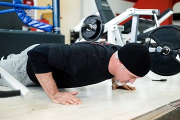 Adult man doing bench press in the gym