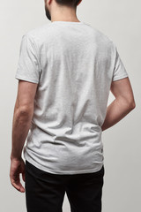 back view of man in white t-shirt with copy space isolated on grey