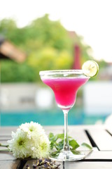 pink margarita cocktail at poolside