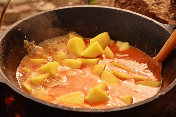 food cooking in stew pot in the nature ,romanian , tocana,traditional ceaun